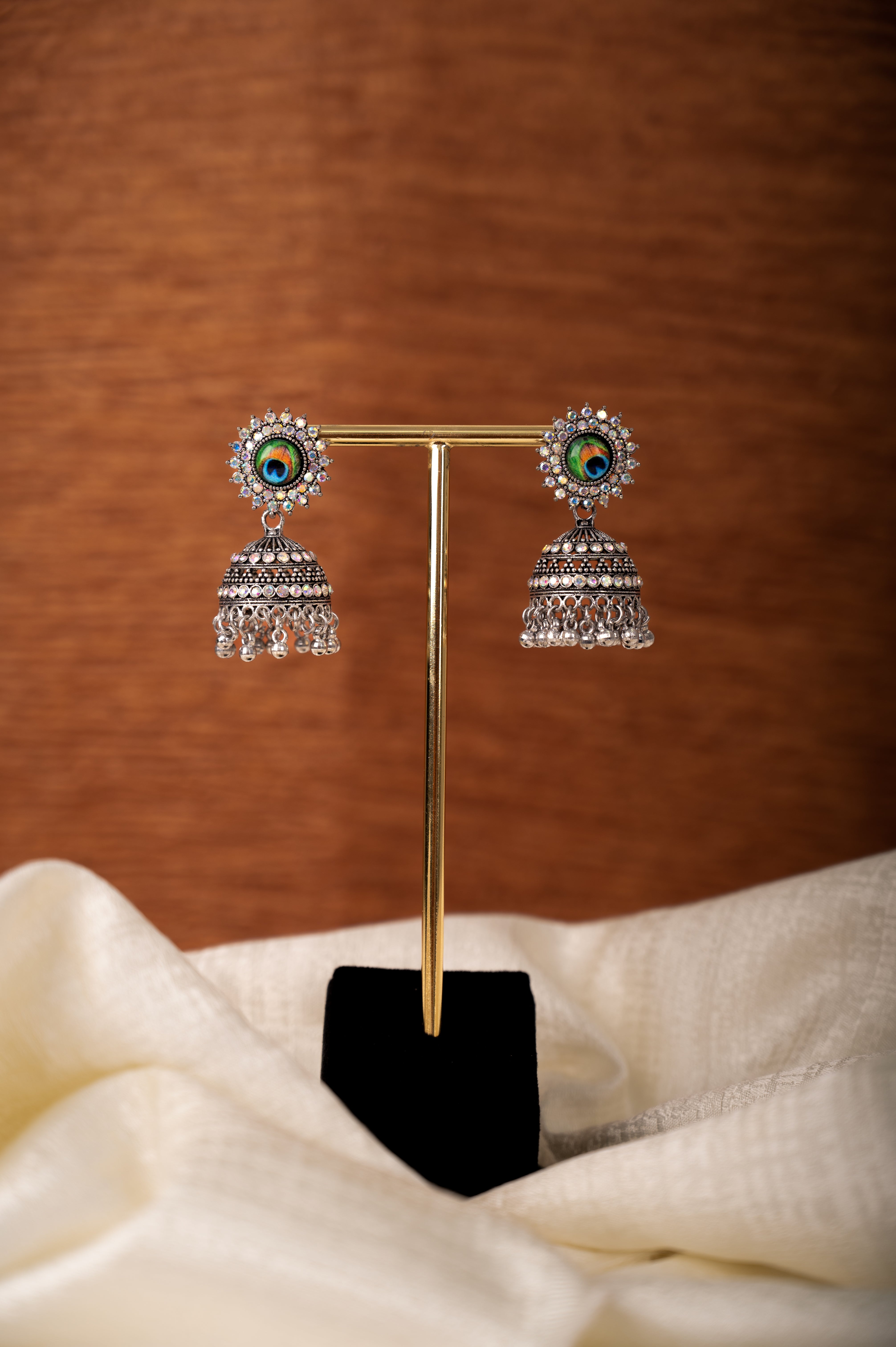 Jhumka Earrings with Peacock Feather Stud Design
