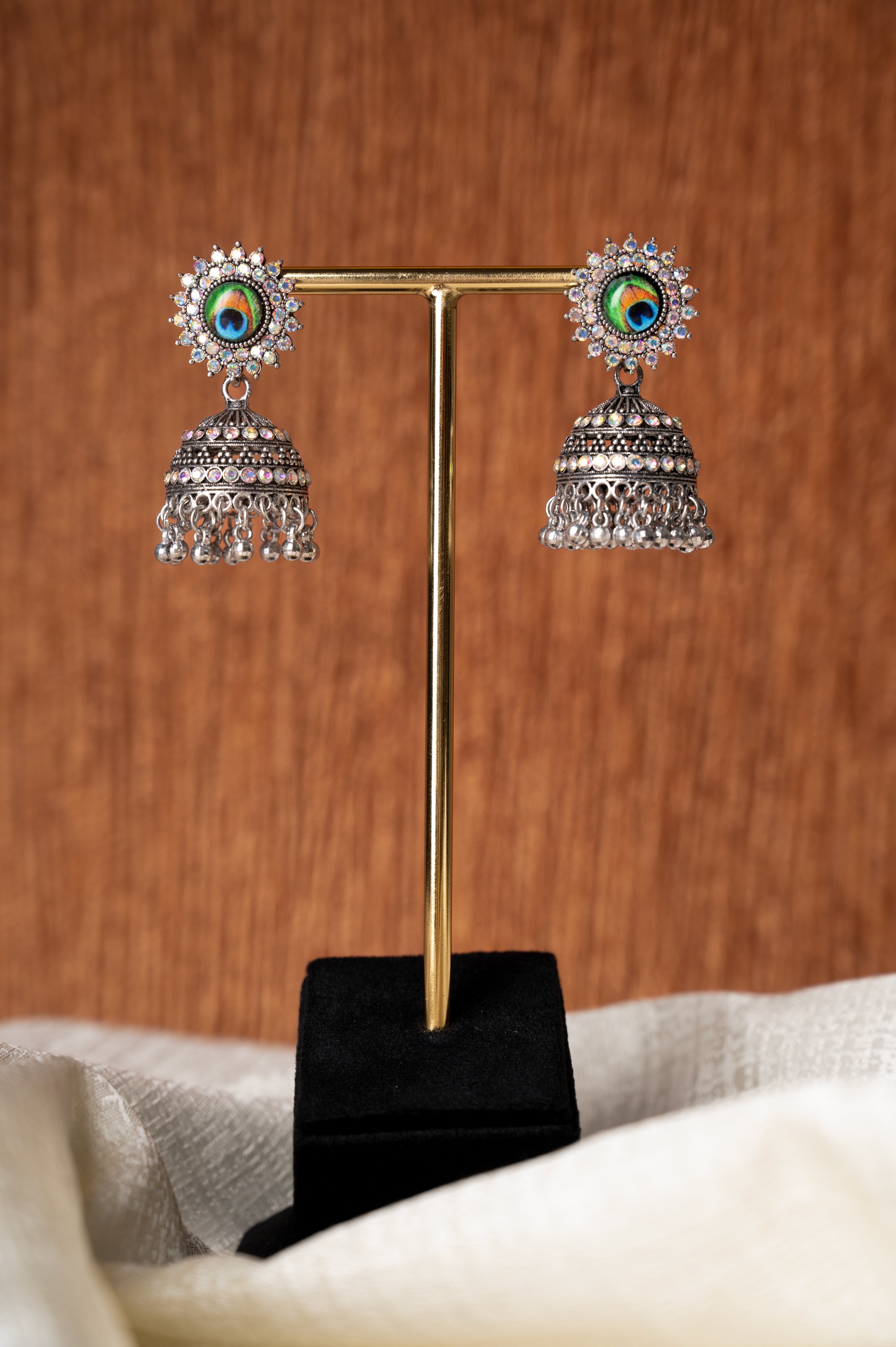 Jhumka Earrings with Peacock Feather Stud Design